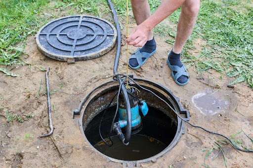 Homeowner performing sump pump maintenance.